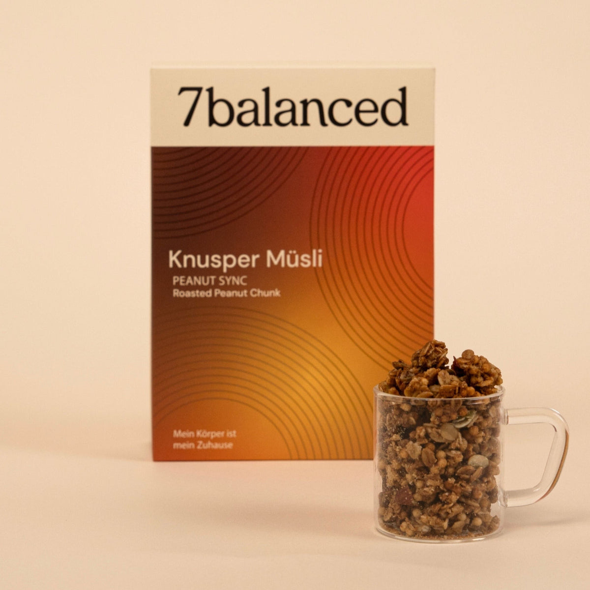Peanut Sync granola pack with glass mug of granola clusters